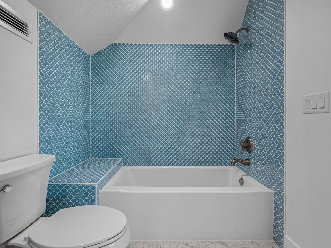 Blue fish-scale mosaic tub surround